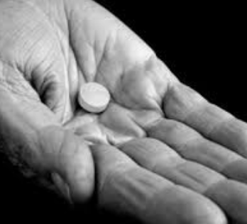 Hands holding pills — modern dependency on isolated supplements versus ancestral beef organ nutrition for women